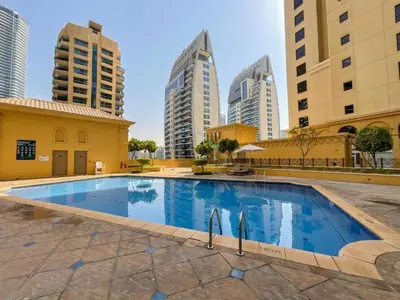 a swimming pool in a city with tall buildings at High Floor 2BR With a View of the Dubai Marina Canal Steps Away From the Beach , Shams 1, JBR by Deluxe Holiday Homes in Dubai