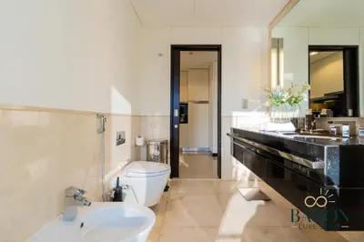 a bathroom with a sink and a toilet and a tub at The Exquisite in Dubai