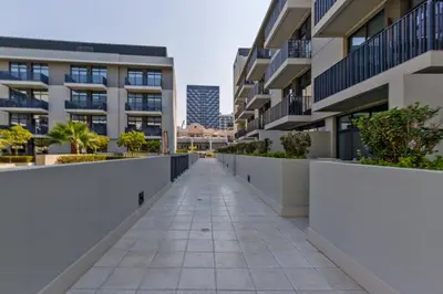 an empty walkway between buildings in a city at Upgraded Brand New Studio in Belgravia 2, JVC - Allsopp & Allsopp in Dubai