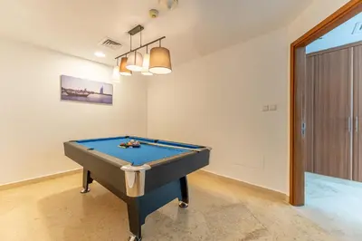 a ping pong table in a room with at HAVN - 2-Storey Apartment with Dubai Marina Views in Dubai