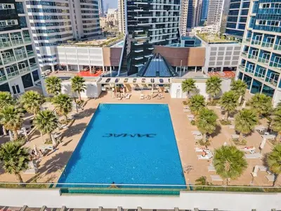 an overhead view of a swimming pool in a city at Vogue Business Bay Damac Maison Prive near Burj Khalifa and Dubai Mall, Studio Apartment with Balcony, Canal and City view, Access to all Amenities in Dubai