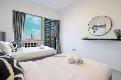 a hotel room with two beds and a mirror at Stay in the #1 Burj & Fountain View 4BR Apartment in Dubai