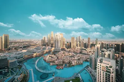 an aerial view of a city with tall buildings at Stay in the #1 Burj & Fountain View 4BR Apartment in Dubai