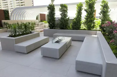 a courtyard with benches and potted plants at Elegant 1BR in JVC in Dubai