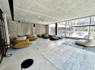 a living room with couches and tables and windows at 2 bedroom apartment Dubai Hills in Dubai