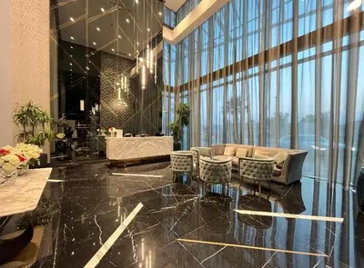 a lobby with a couch and chairs in a building at Luxury 2BR above the clouds on38 in Dubai