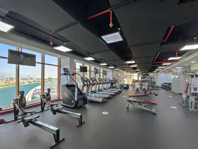 a gym with treadmills and machines in a building at Silkhaus Cozy Seashore Studio in Palm Jumeirah in Dubai