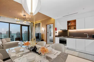 a kitchen and living room with a table and chairs at Novity Signature Homes in Dubai
