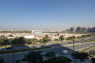 a view of a highway with palm trees and buildings at Frank Porter - Prive Residence in Dubai