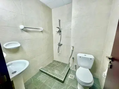 a bathroom with a shower and a toilet and a sink at Haifa building in Dubai