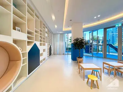 an office with a table and chairs and a desk and shelves at Luxury 1BR at Grande Downtown with Iconic Views in Dubai