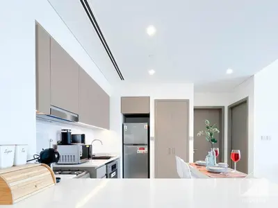 a kitchen with white walls and white appliances at Luxury 1BR at Grande Downtown with Iconic Views in Dubai