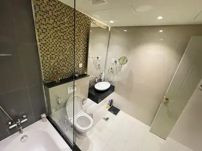 a bathroom with a shower and a toilet and a sink at Unmatched luxury perfectly located next to Dubai Mall and Burj Khalifa in Dubai