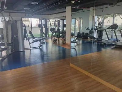 a gym with treadmills and elliptical machines at Lux 1BR Apt with BurjKhalifa Views in DowntownDubai in Dubai