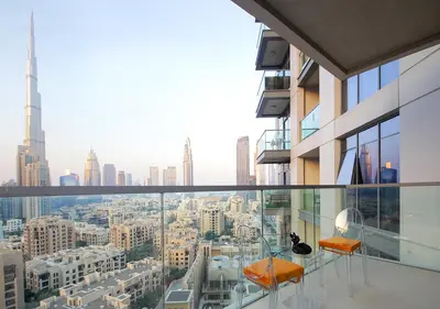 a balcony with two chairs and a view of a city at Lux 1BR Apt with BurjKhalifa Views in DowntownDubai in Dubai