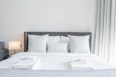 a white bed with two white towels on it at Bright & Modern Studio - Legacy By Sunrise - Arjan in Dubai