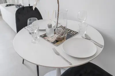 a white table with a plate and glasses on it at Bright & Modern Studio - Legacy By Sunrise - Arjan in Dubai