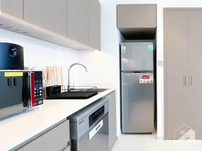 a white kitchen with a refrigerator and a sink at Grande Luxury 1B With Balcony & City Views in Dubai