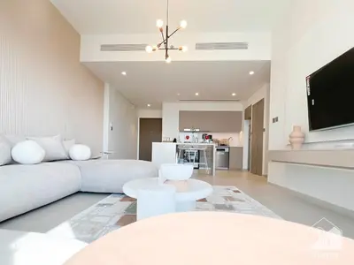 a living room with a couch and a tv at Grande Luxury 1B With Balcony & City Views in Dubai