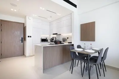 a kitchen and dining room with a table and chairs at Binghatti House in JVC - New Apartment in Dubai
