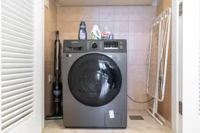 a washing machine in a room with at Stylish 1-Bedroom with Breathtaking Views at Dubai Marina in Dubai
