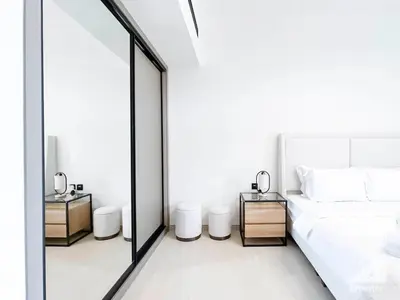 a bedroom with a white bed and a large mirror at Elegant 2 Bedroom Apartment -Binghatti Emerald JVC in Dubai