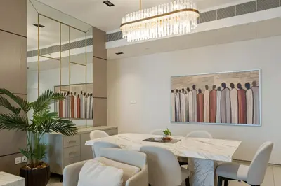 a dining room with a table and white chairs at Werova - Sea View 3BR with Hotel Facilities Access in Dubai