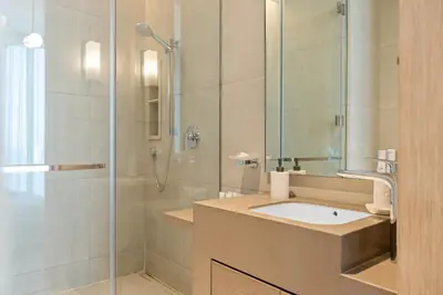 a bathroom with a sink and a shower at Werova - Sea View 3BR with Hotel Facilities Access in Dubai