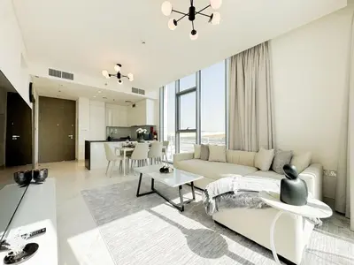 a living room with a couch and a table at Azure - 1-Bed Luxury by Crystal Lagoon, Downtown in Dubai