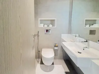 a white bathroom with a toilet and a sink at Azure - 1-Bed Luxury by Crystal Lagoon, Downtown in Dubai