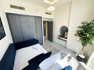 a bedroom with a bed and a potted plant at Great deal Magnificent Brand New with Private PooL in Dubai
