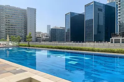 a large blue swimming pool on top of a building at Keyrock Living - Luxury 1BR with Lake View at Reva in Dubai
