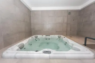 a large bath tub in a room with at StayShort - Sleek Studio in Jumeirah Village Triangle in Dubai
