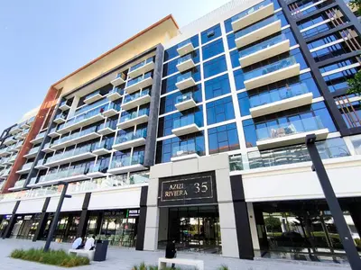 a large building with a clock in front of it at 10 Mins from Downtown Pool Gym Large Terrace in Dubai