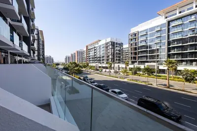 a view from the balcony of a building with cars on the street at 10 Mins from Downtown Pool Gym Large Terrace in Dubai