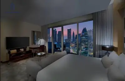 a hotel room with a bed and a large window at Creston Suites The Dubai Mall Residences in Dubai
