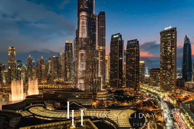 a nighttime view of a large city with tall buildings at LUX The EMAAR Fashion Avenue Studio 2 in Dubai