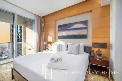 a hotel room with a bed with towels on it at LUX The EMAAR Fashion Avenue Studio 2 in Dubai