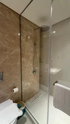 a shower with a glass door in a bathroom at Seaside Elegance 1BR at Emaar Beachfront in Dubai
