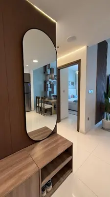 a mirror in a room with a living room at Seaside Elegance 1BR at Emaar Beachfront in Dubai