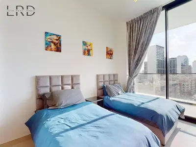 two beds in a room with a window at Modern Smart Home 2BR with Private Pool in JVC in Dubai