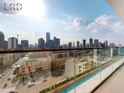 a view of the city from the balcony of a building at Modern Smart Home 2BR with Private Pool in JVC in Dubai