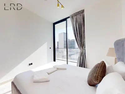 a bedroom with a white bed and a large window at Modern Smart Home 2BR with Private Pool in JVC in Dubai