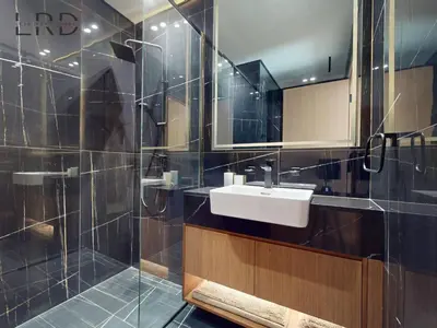 a bathroom with a sink and a shower at Modern Smart Home 2BR with Private Pool in JVC in Dubai