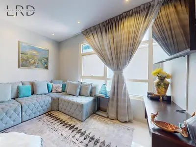 a living room with a couch and a window at Stylish 2BR Apartment Steps from Metro and Marina Mall in Dubai