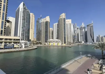 a view of a city with a river with buildings at Luxurious 2BR Stay Marina View in Dubai