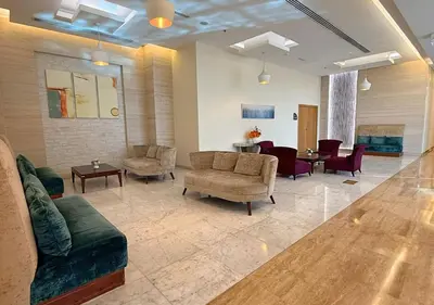 a waiting room with couches and chairs and tables at Capital Bay Tower B Comfort Studio in Dubai
