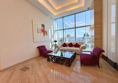a living room with a couch and a table and chairs at Capital Bay Tower B Comfort Studio in Dubai