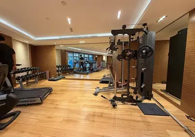 a gym with a bunch of treadmills and machines at Capital Bay Tower B Comfort Studio in Dubai