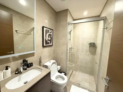 a bathroom with a shower and a toilet and a sink at Great Location Near City Modern Sleeps 4 Guests in Dubai